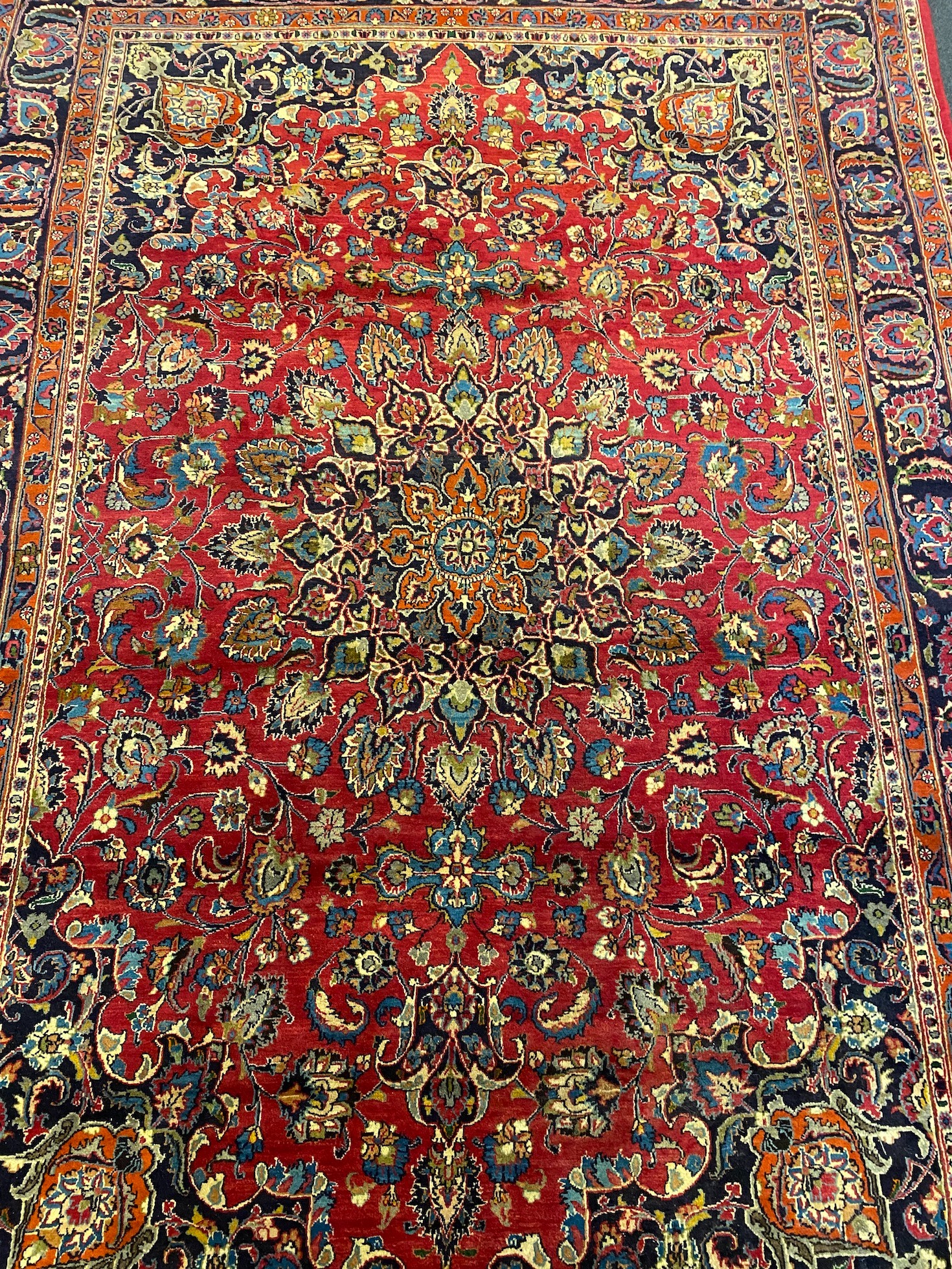 A Kashan claret ground carpet, 375cm x 250cm